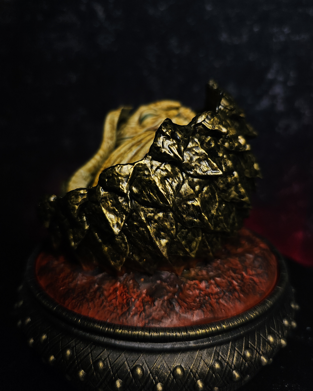 Hand-painted baby dragon egg figurine inspired by House of the Dragon and Syrax. Fantasy resin collectible with volcanic dragon egg display.