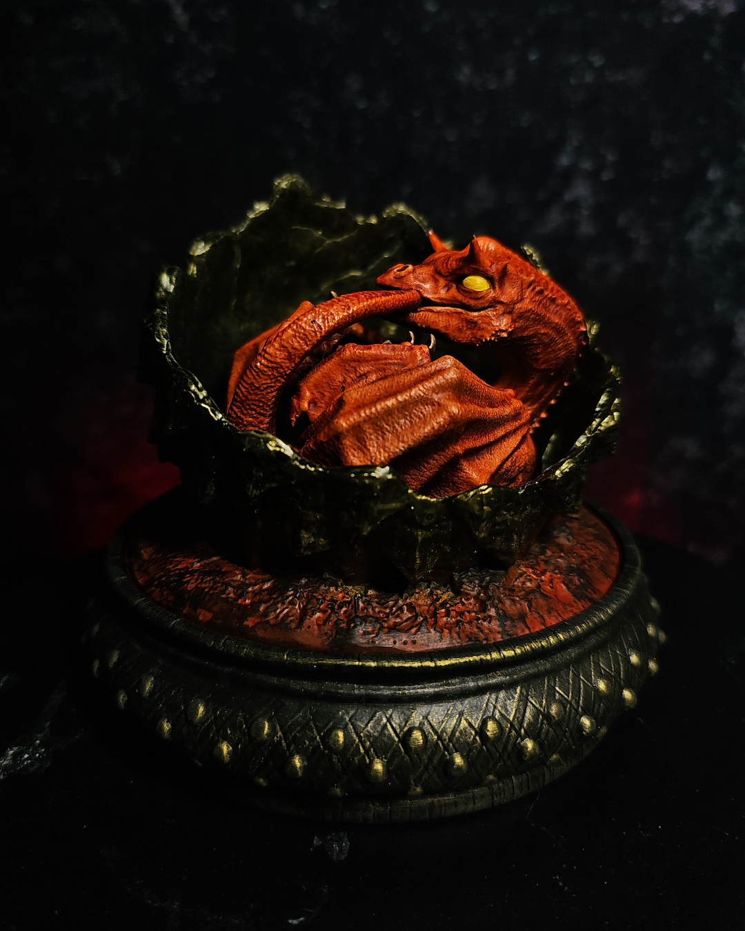 Detailed close-up of a red baby dragon embryo with yellow eyes inside a cracked fantasy dragon egg