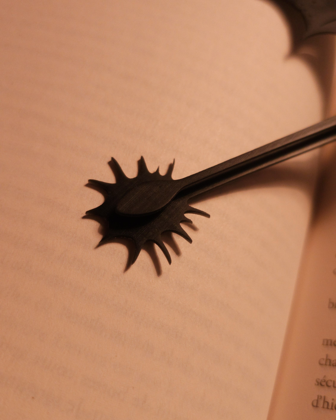 Gros plan sur la queue épineuse du marque-page dragon en résine noire, montrant la finesse de l’impression 3D et un style inspiré de Fourth Wing.
