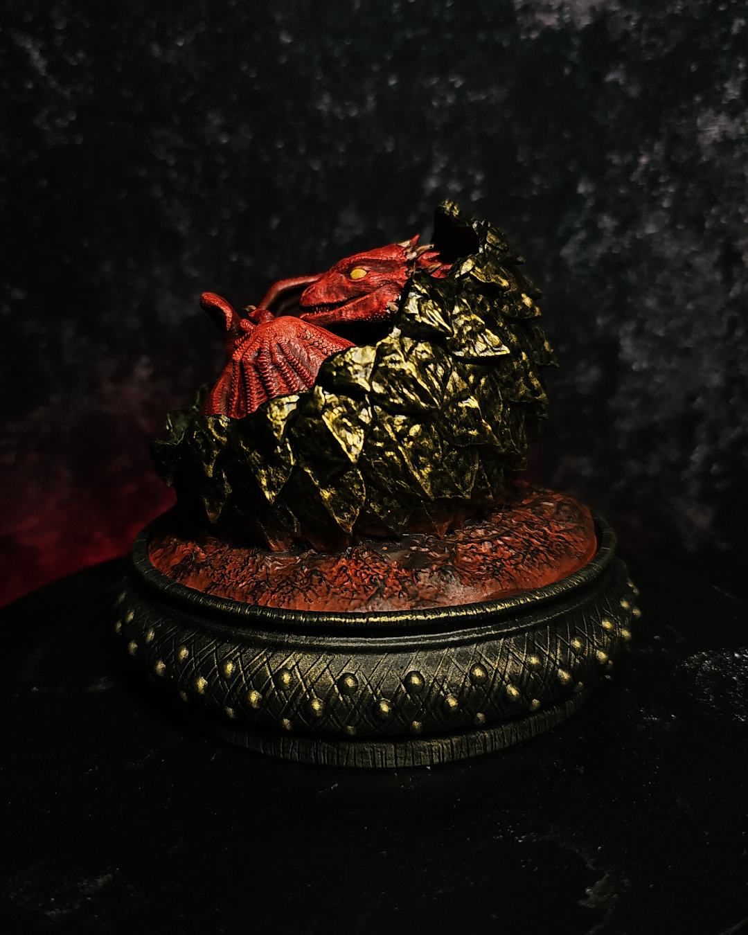 Fantasy baby dragon inspired by Meleys House of the Dragon. Hand-painted resin figurine with volcanic dragon egg and dark fantasy display base.