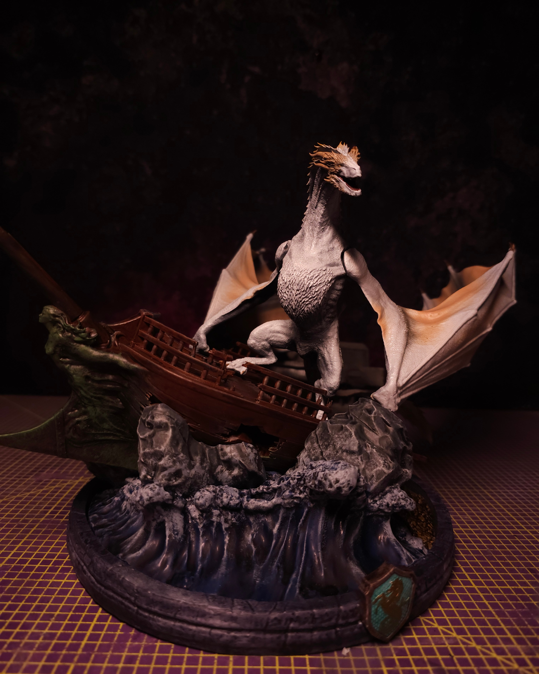 Seasmoke dragon resin statue posed on rocky cliffs with long tail and extended wings, inspired by the wild dragons of Dragonstone.