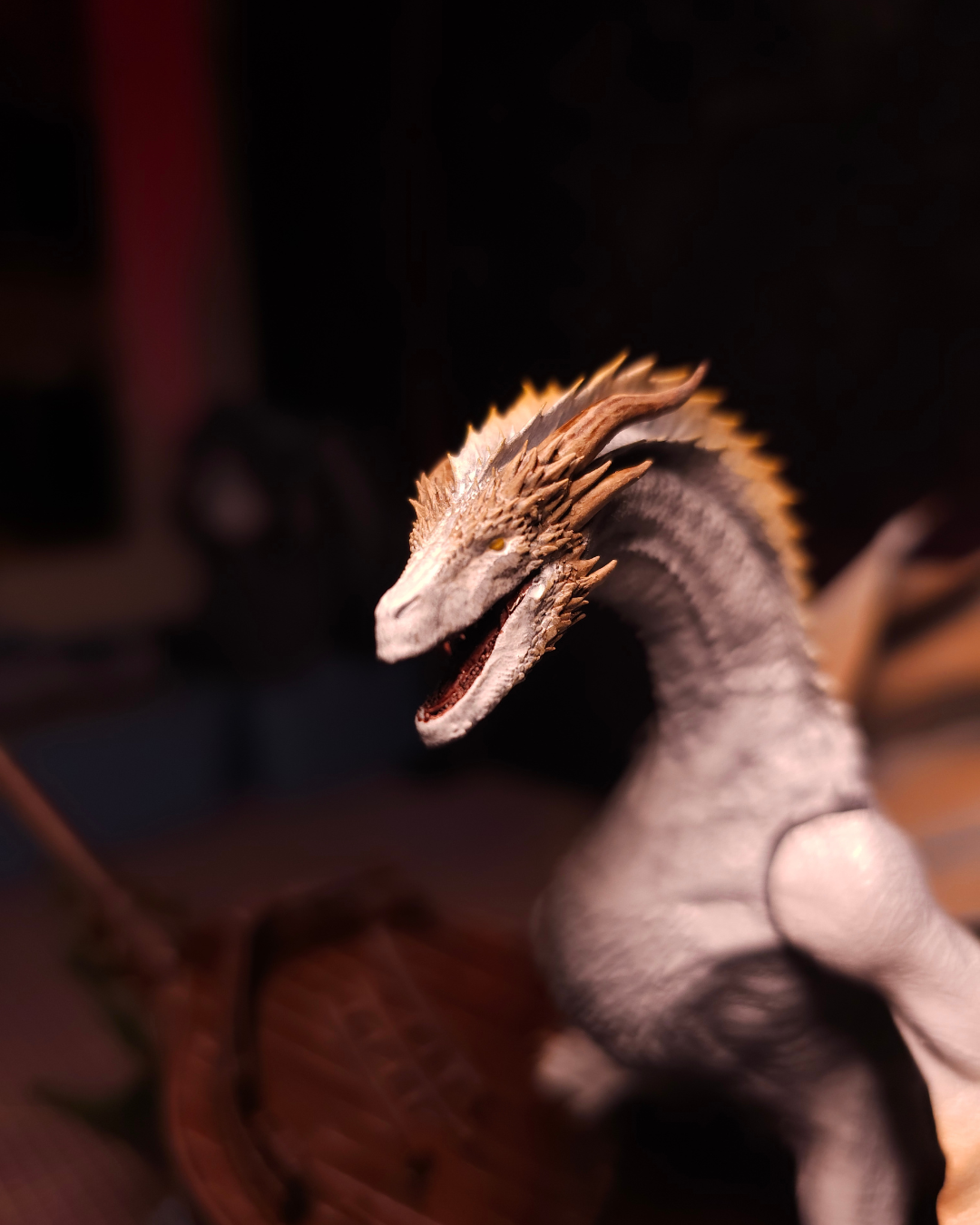 Close-up of Seasmoke dragon head with silver scales and golden horns on a detailed resin figurine inspired by House of the Dragon.