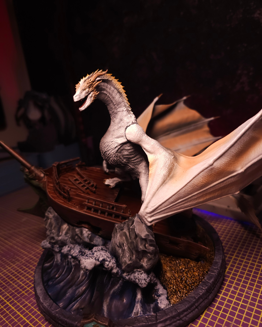 White Seasmoke dragon figurine perched on a Velaryon ship surrounded by ocean waves, inspired by House of the Dragon and Dragonstone lore.